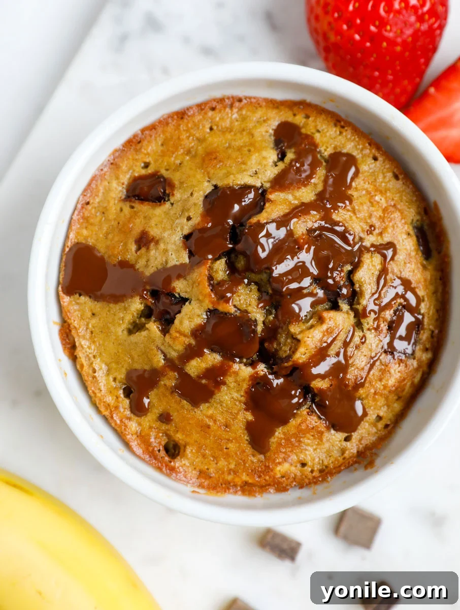 3 Irresistible Baked Oats Recipes 9 A charming ramekin showcasing delicious baked oatmeal, adorned with slices of fresh banana and delightful chocolate chips.