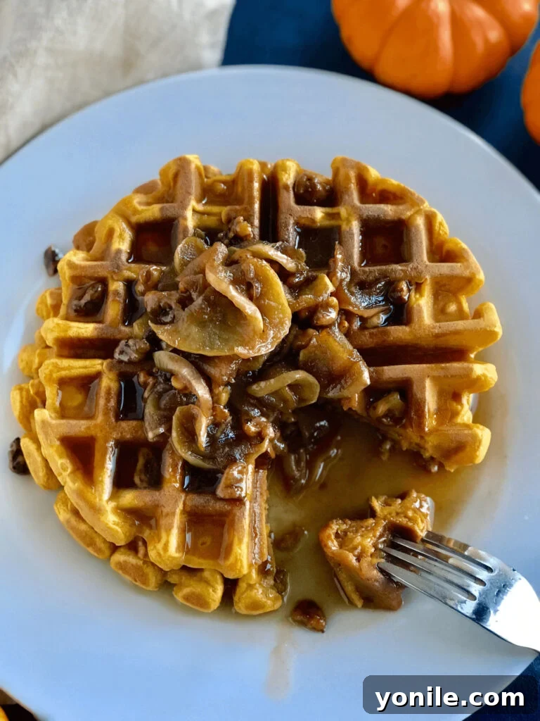 Delicious Pumpkin Waffles topped with candied walnuts and maple syrup