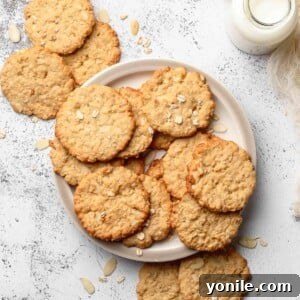 Crispy Almond Cookie on a plate with a bottle of milk next to it.