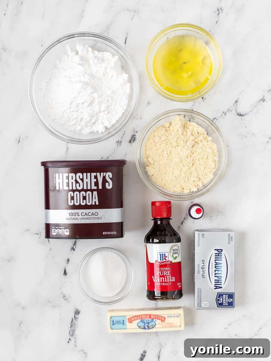 A curated collection of fresh ingredients laid out, ready for making red velvet macarons, including almond flour, powdered sugar, eggs, cocoa, and cream cheese.