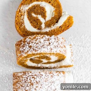 Slices of pumpkin cake roll dusted with powdered sugar