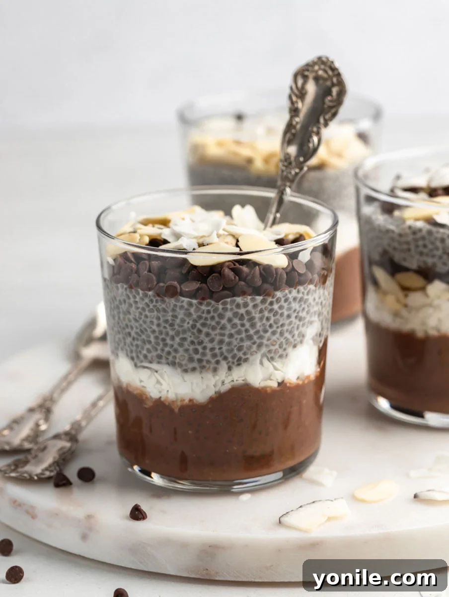 front view shot of almond joy chia pudding with a spoon in the cup