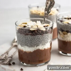 front view shot of almond joy chia pudding with a spoon in the cup