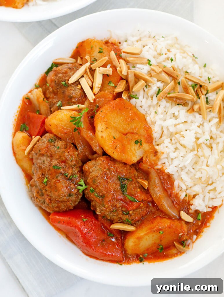 Lebanese Kofta Stew for Beginners 12 A beautifully plated serving of Kafta and Potato Stew with vermicelli rice, ready to be enjoyed.