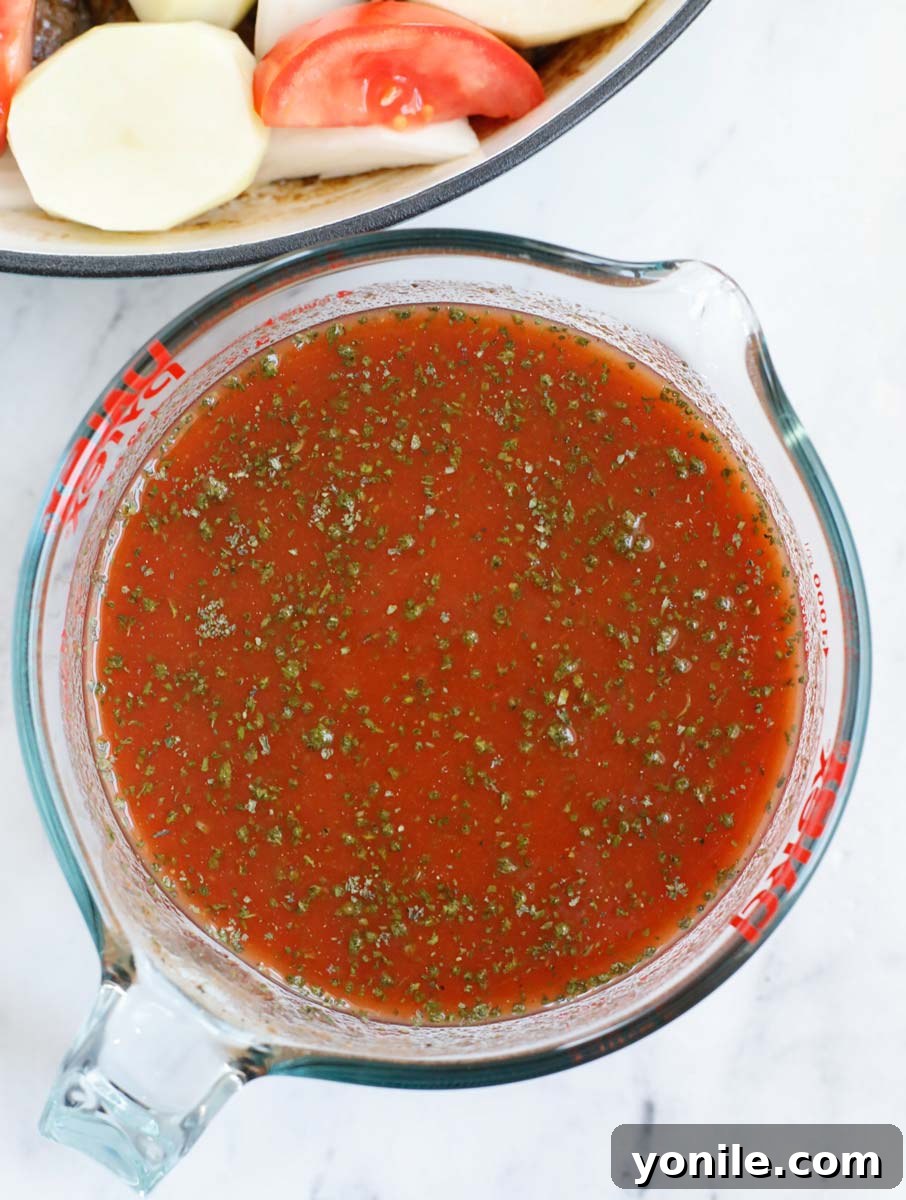 Lebanese Kofta Stew for Beginners 10 A bowl of kafta stew sauce, featuring tomato sauce and spices, ready to be poured over the stew ingredients.