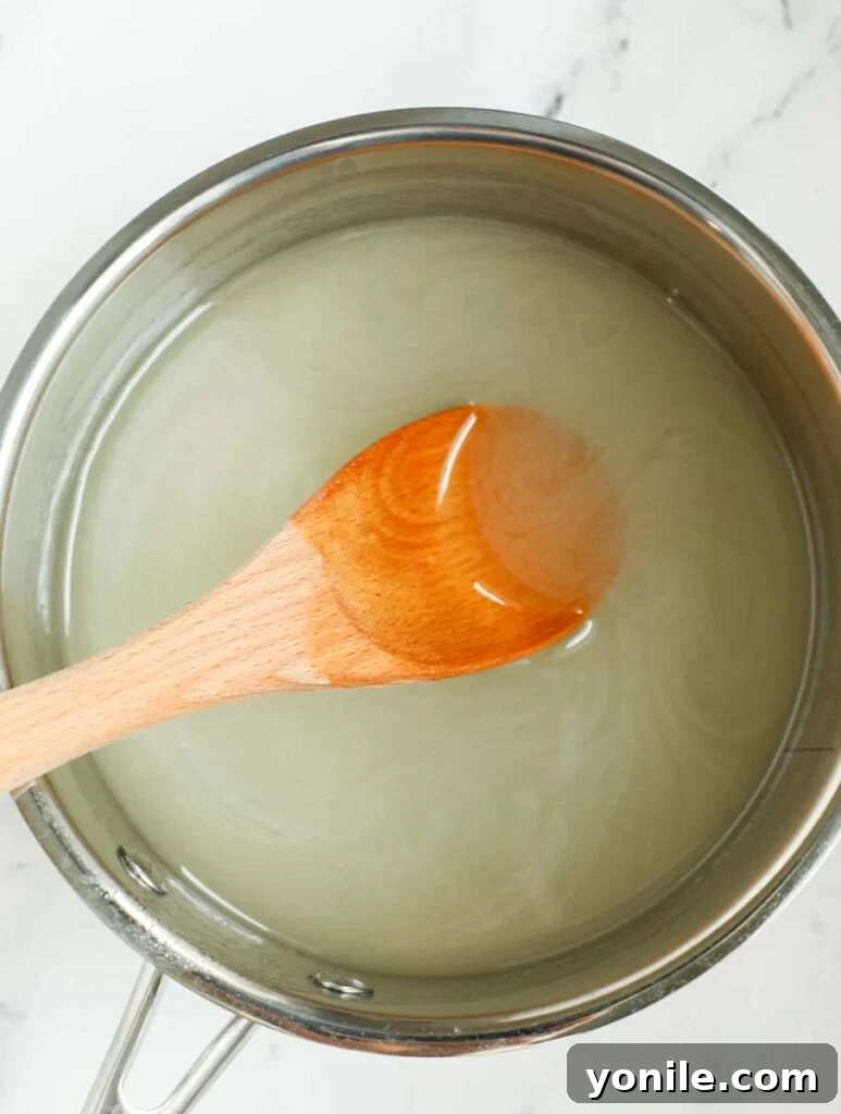 Stirring ingredients for syrup in a sauce pan.