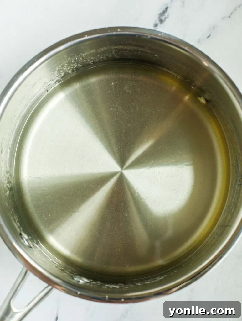 Sugar syrup inside a saucepan.