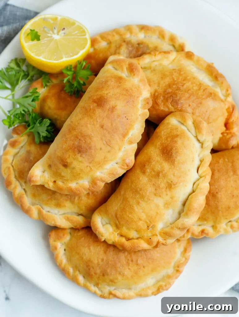 A platter of freshly baked individual meat pies.