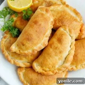 A platter of freshly baked individual meat pies.