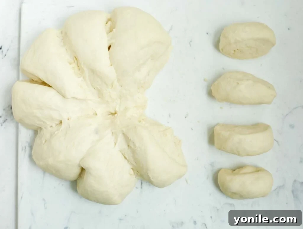 Cutting dough to shape into small dough balls.