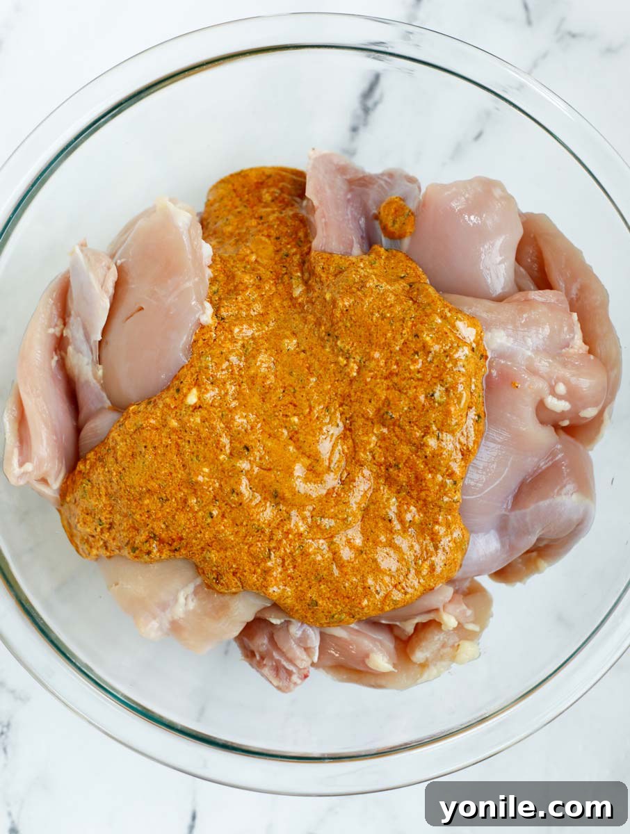 Marinade poured over top of chicken thighs before and after mixing together