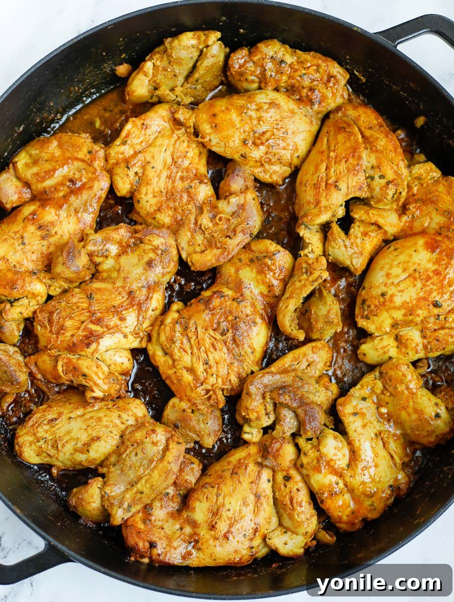 Chicken shawarma being seared in a cast iron after cooking