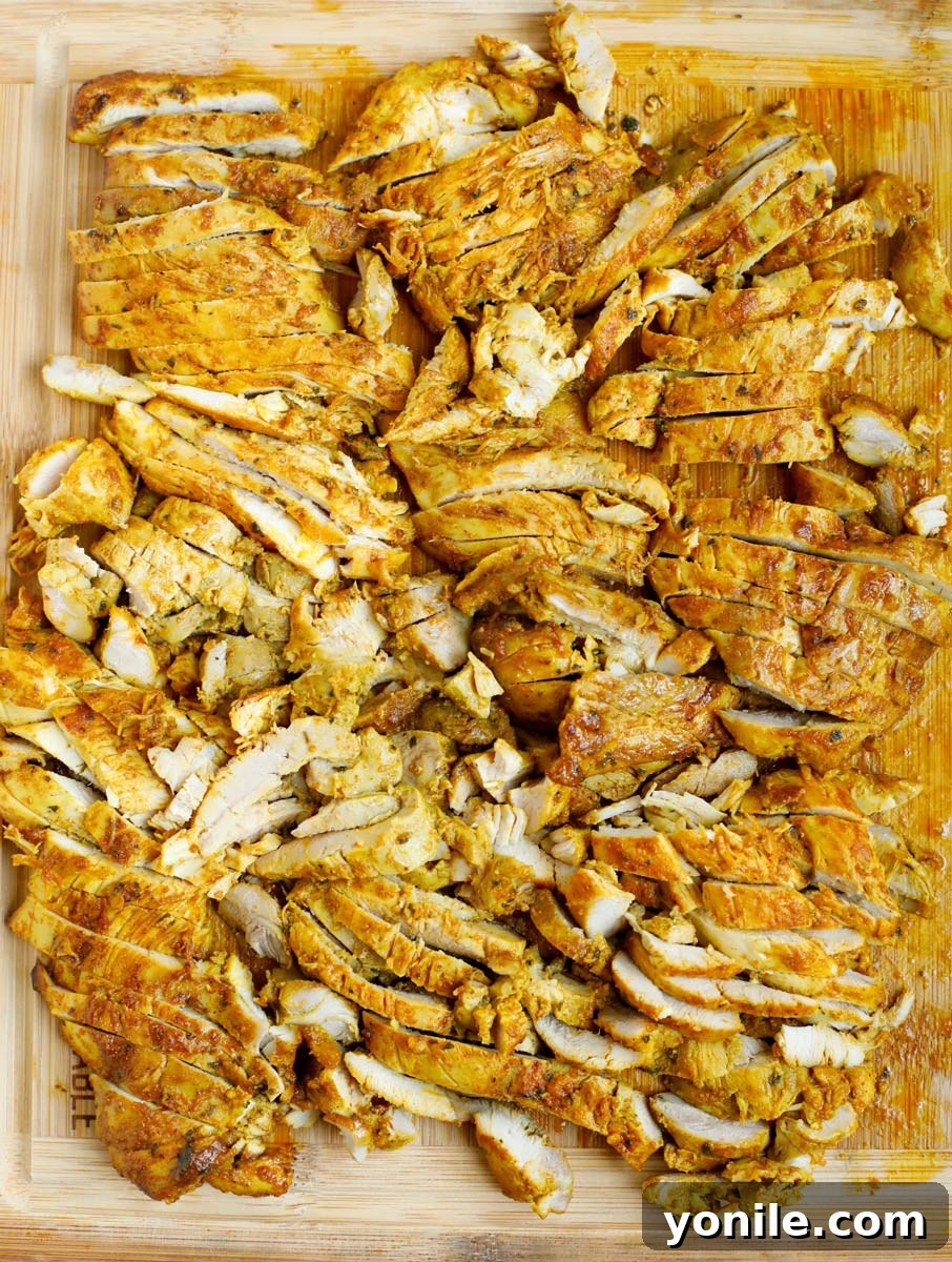 Chicken shawarma on a cutting board, cut into bite sized pieces.