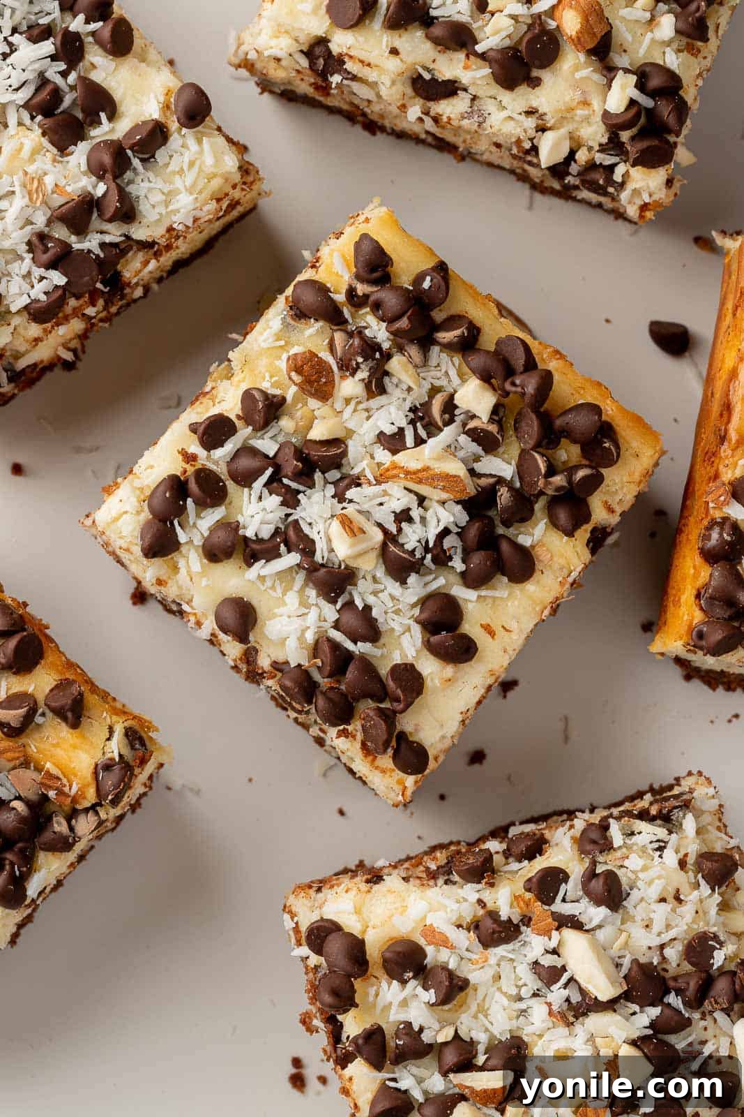 An appetizing spread of Almond Joy cheesecake bars, artfully arranged on a serving platter, ready for guests.