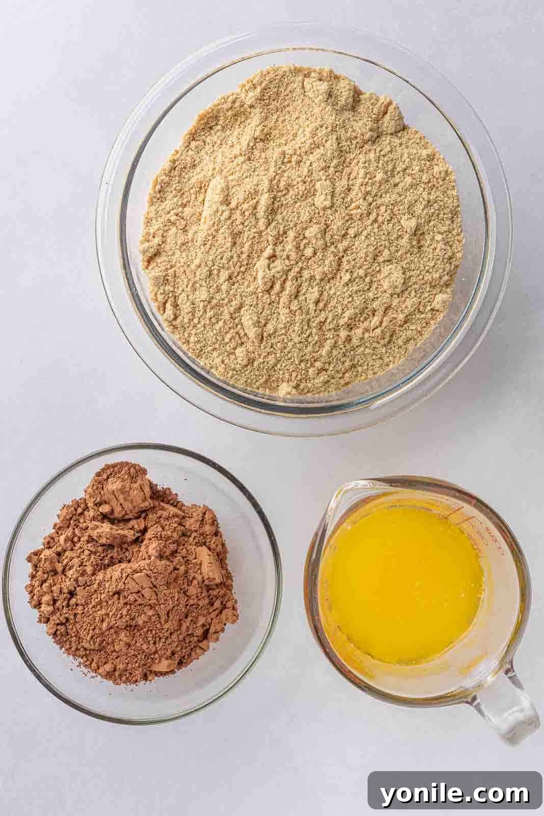 Ingredients for the chocolate graham cracker crust: graham crackers, melted butter, and cocoa powder in a bowl.