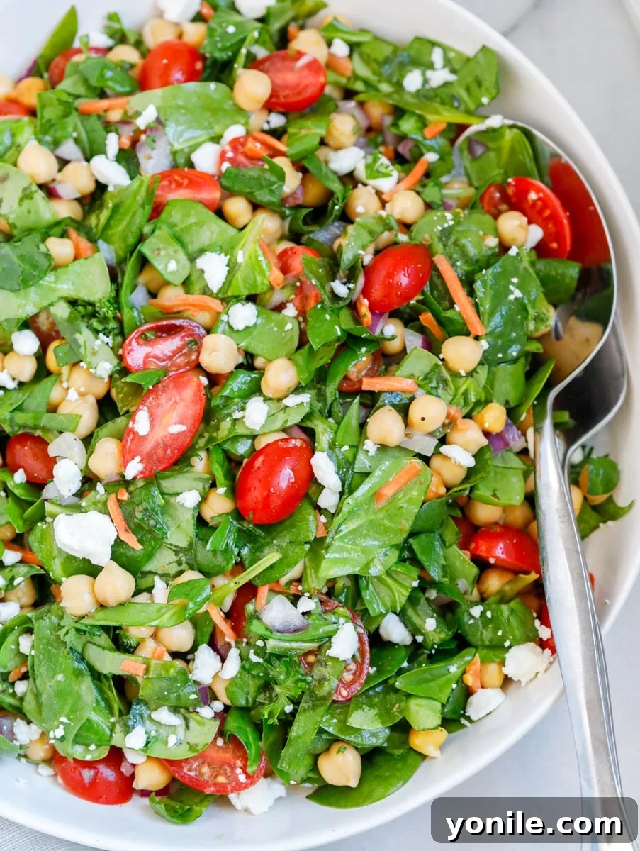 A close-up shot of the finished easy chickpea spinach salad, highlighting its fresh texture and ingredients.