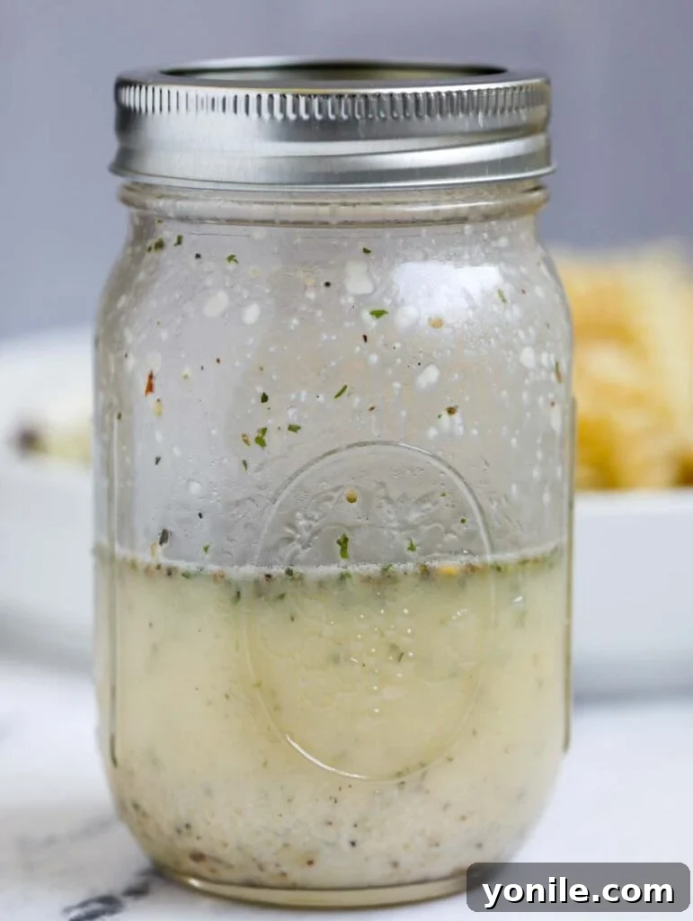 Vibrant Mediterranean Pasta Medley 4 A mason jar filled with freshly made Greek dressing, ready to be poured.