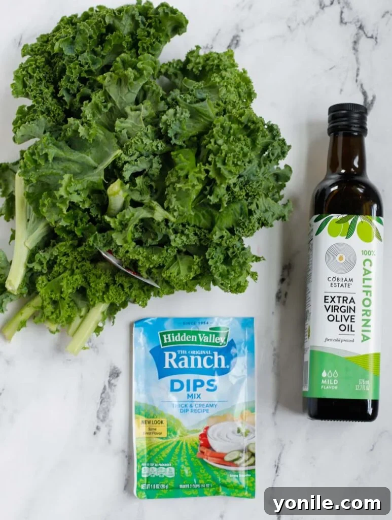 Golden Air Fryer Kale Crisps 3 Fresh kale leaves, a bottle of olive oil, and a small dish of ranch seasoning, the essential ingredients for crispy kale chips.