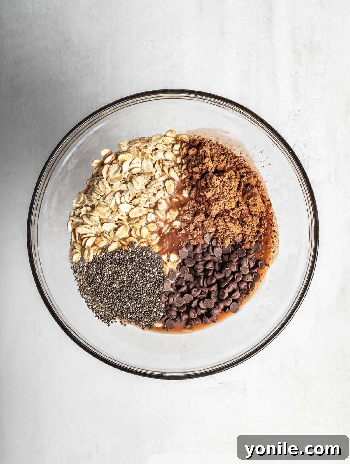 ingredients of chocolate overnight oats in a bowl before mixing