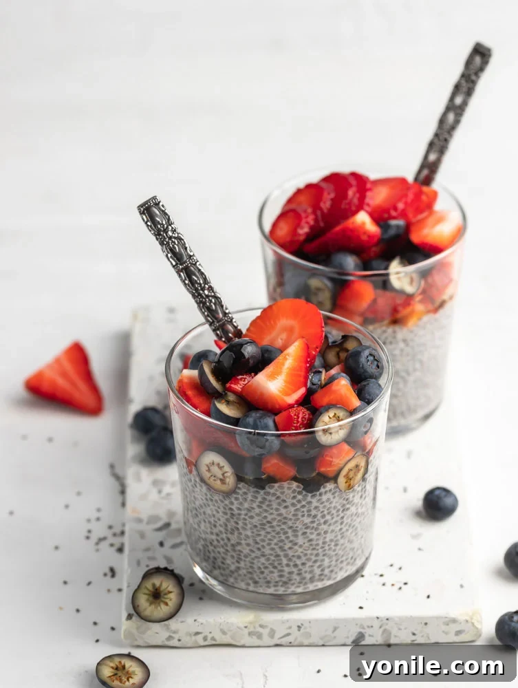 two chia seed puddings in a cup topped with fruits