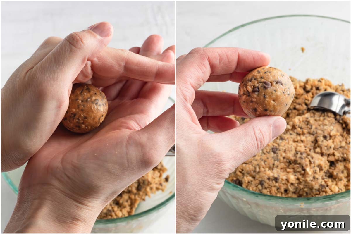 Effortless Energy Bites 5 A close-up photo demonstrating the proper technique for forming a No-Bake Energy Ball with two hands.