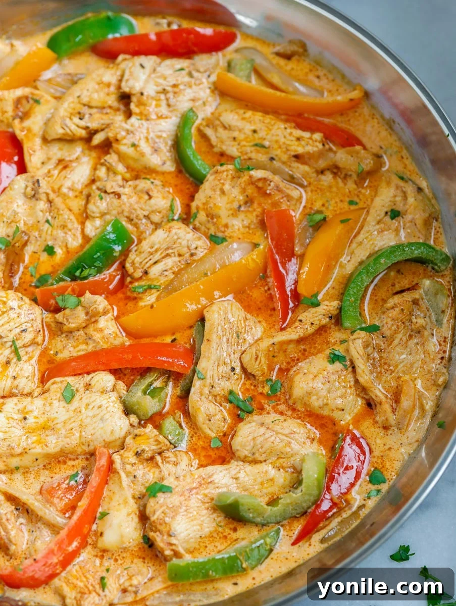 A perfectly cooked pan of creamy chicken fajita skillet, ready to be served.