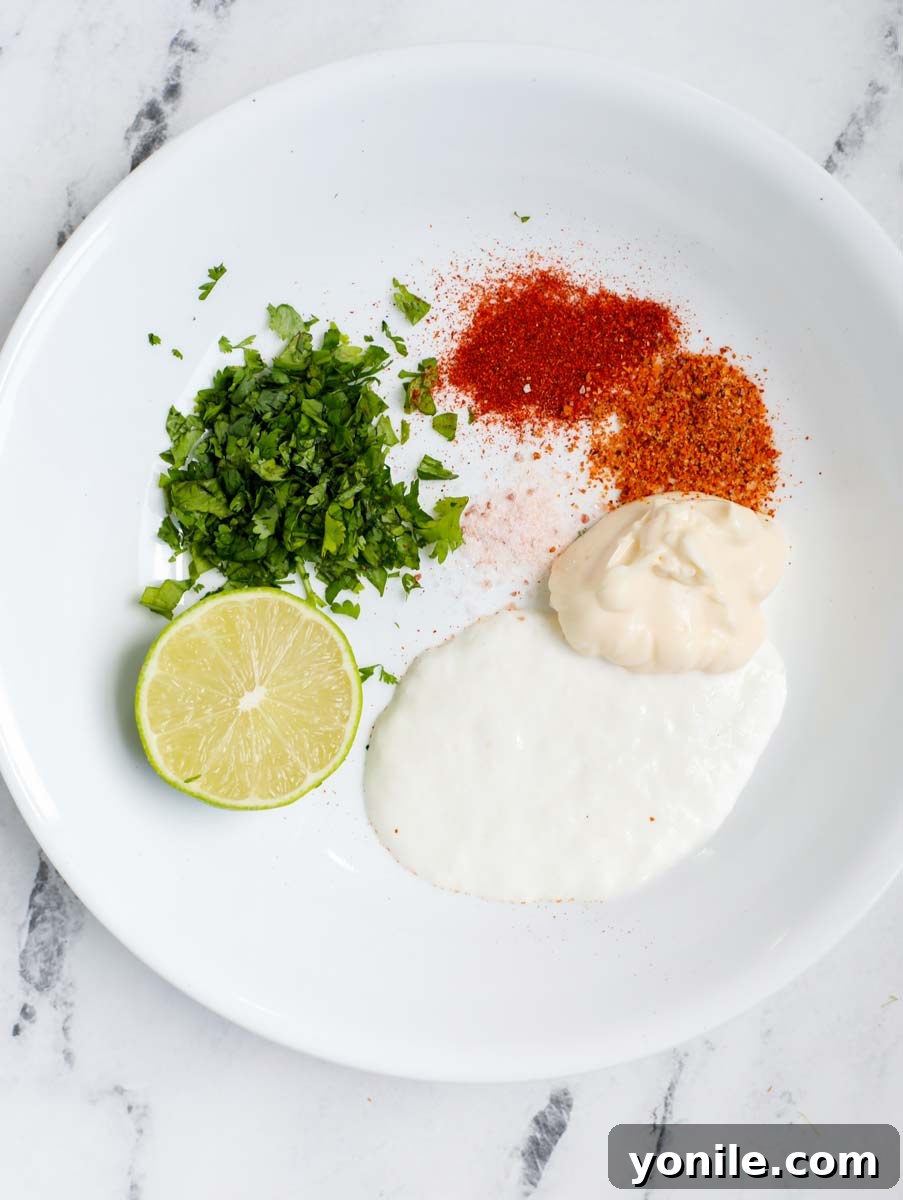 Ingredients for Mexican street corn sauce in a bowl, ready to be mixed.