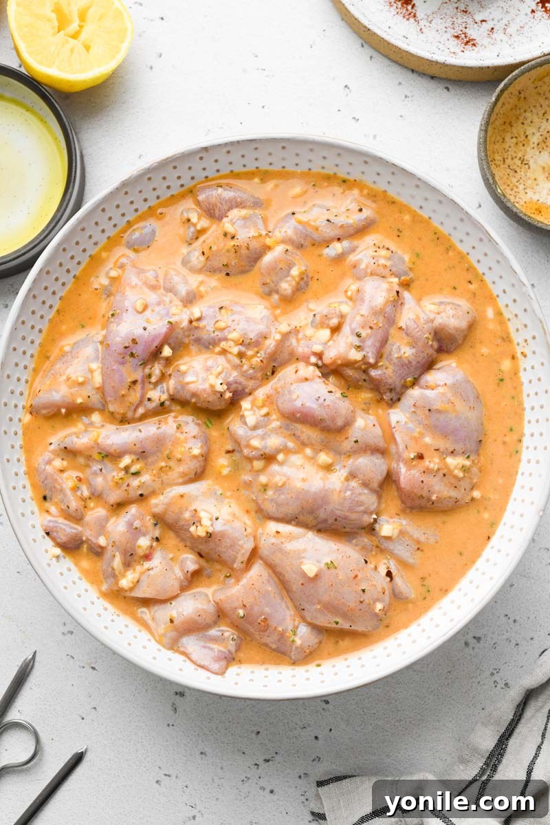 Zesty Lemon Garlic Chicken Skewers 4 chicken marinated in the lemon garlic sauce in a bowl