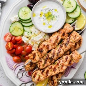 Top-down shot of the Greek chicken skewer dish served with sides