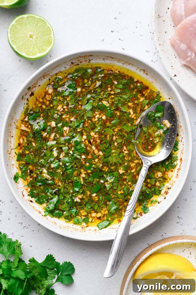 Zesty Grilled Cilantro Lime Chicken 4 Top down shot of the vibrant green cilantro lime marinade in a glass bowl.