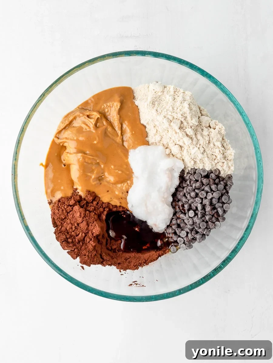 All ingredients for brownie energy bites in a bowl, ready to be mixed.