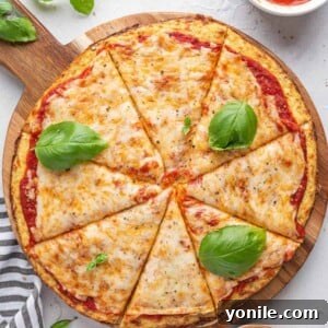 top down shot of cauliflower pizza with basil leaves on top
