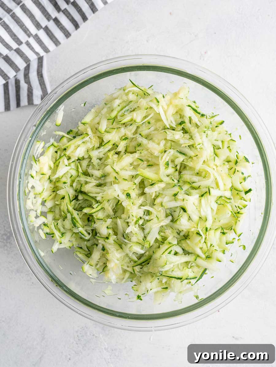 Crispy Zucchini Bites 4 A bowl of freshly shredded zucchini, prepared for mixing.
