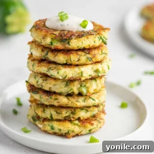 A stack of golden, crispy zucchini fritters ready to be served.