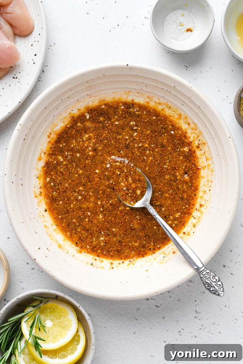 A bowl filled with a rich, golden honey mustard sauce, ready for the chicken.