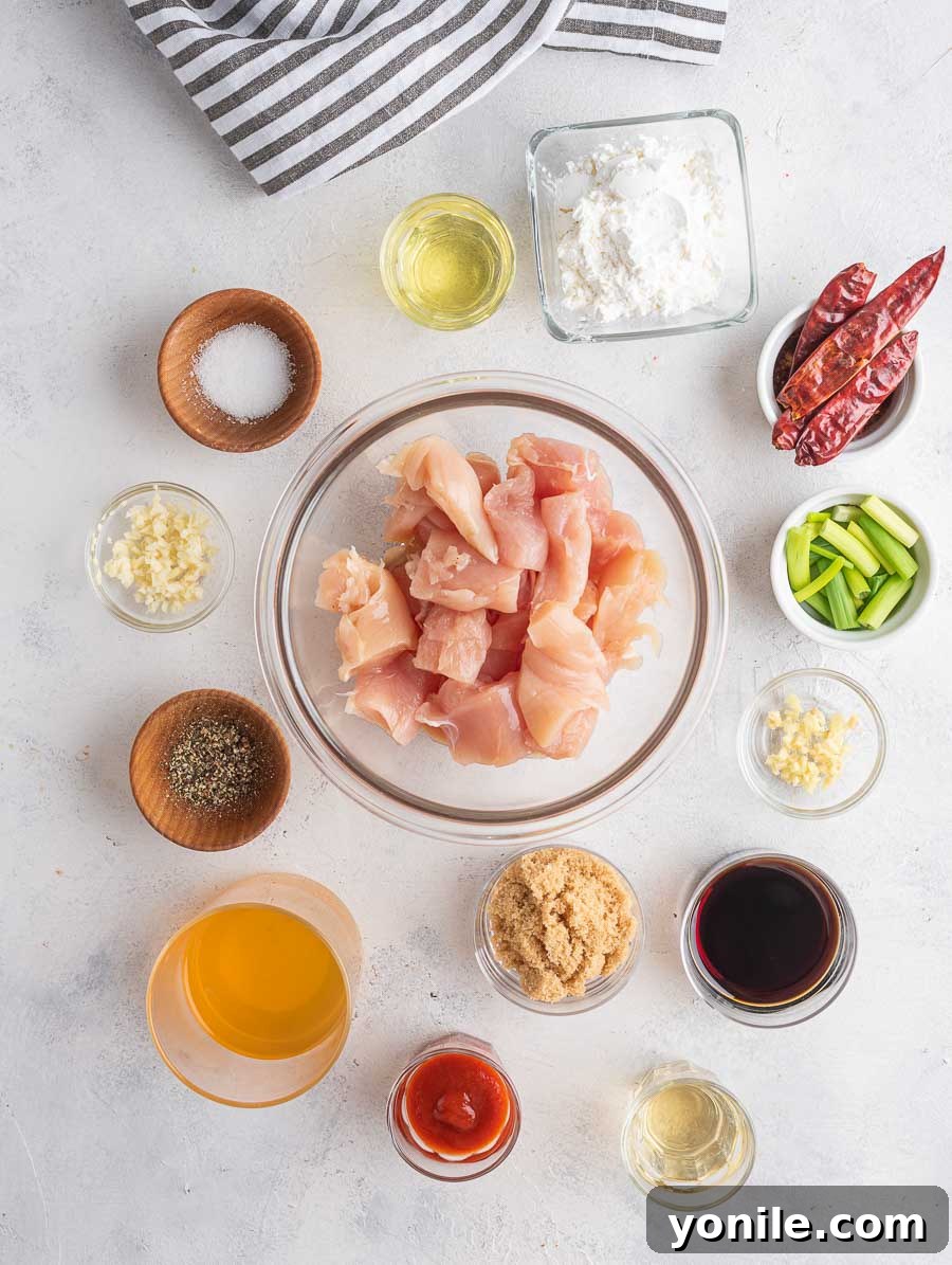 No-Fuss Mongolian Chicken 3 Various ingredients for Mongolian Chicken laid out on a wooden surface