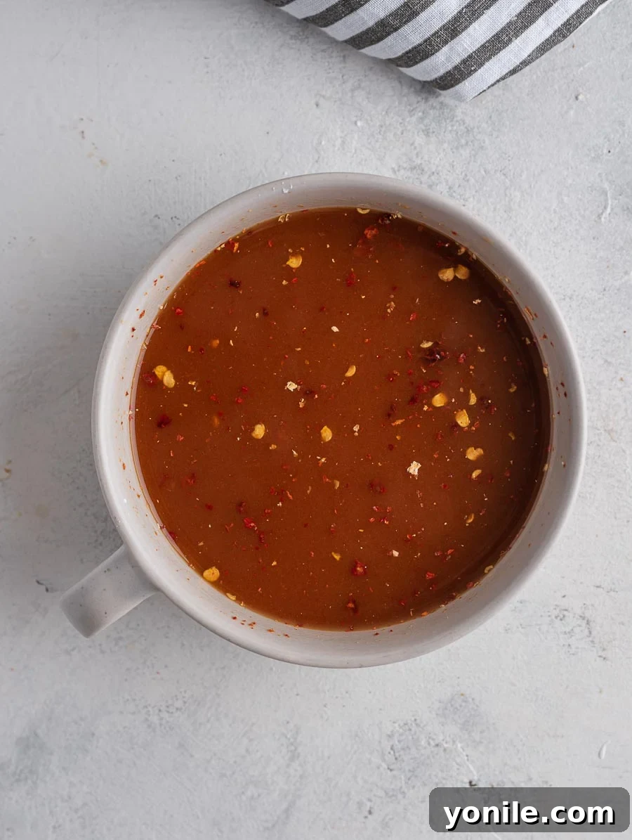 No-Fuss Mongolian Chicken 4 Mongolian sauce in a measuring cup, showcasing its rich color
