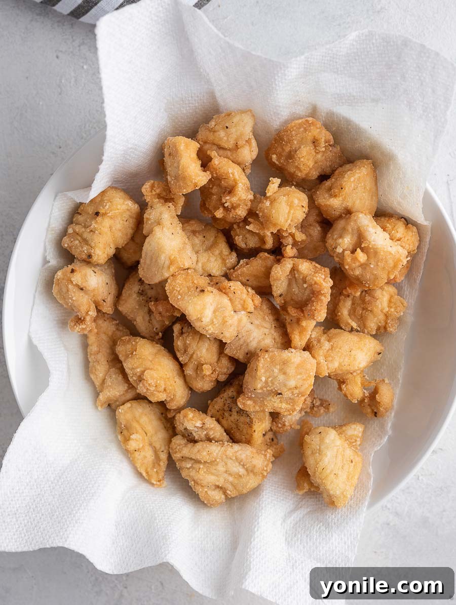 No-Fuss Mongolian Chicken 6 Crispy fried chicken bites resting on a paper towel-lined bowl