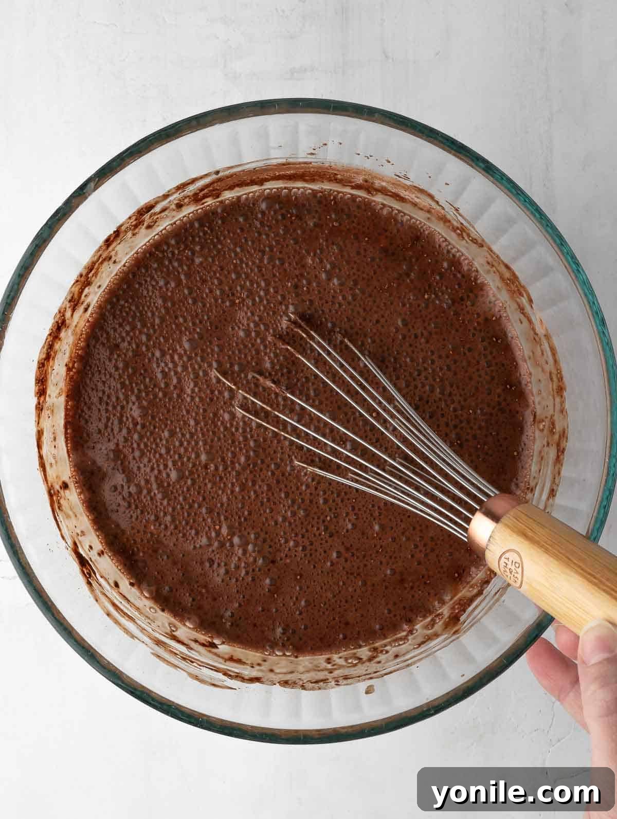 The perfectly mixed and thickened chocolate chia protein pudding rests in a bowl, ready for chilling and garnishing.