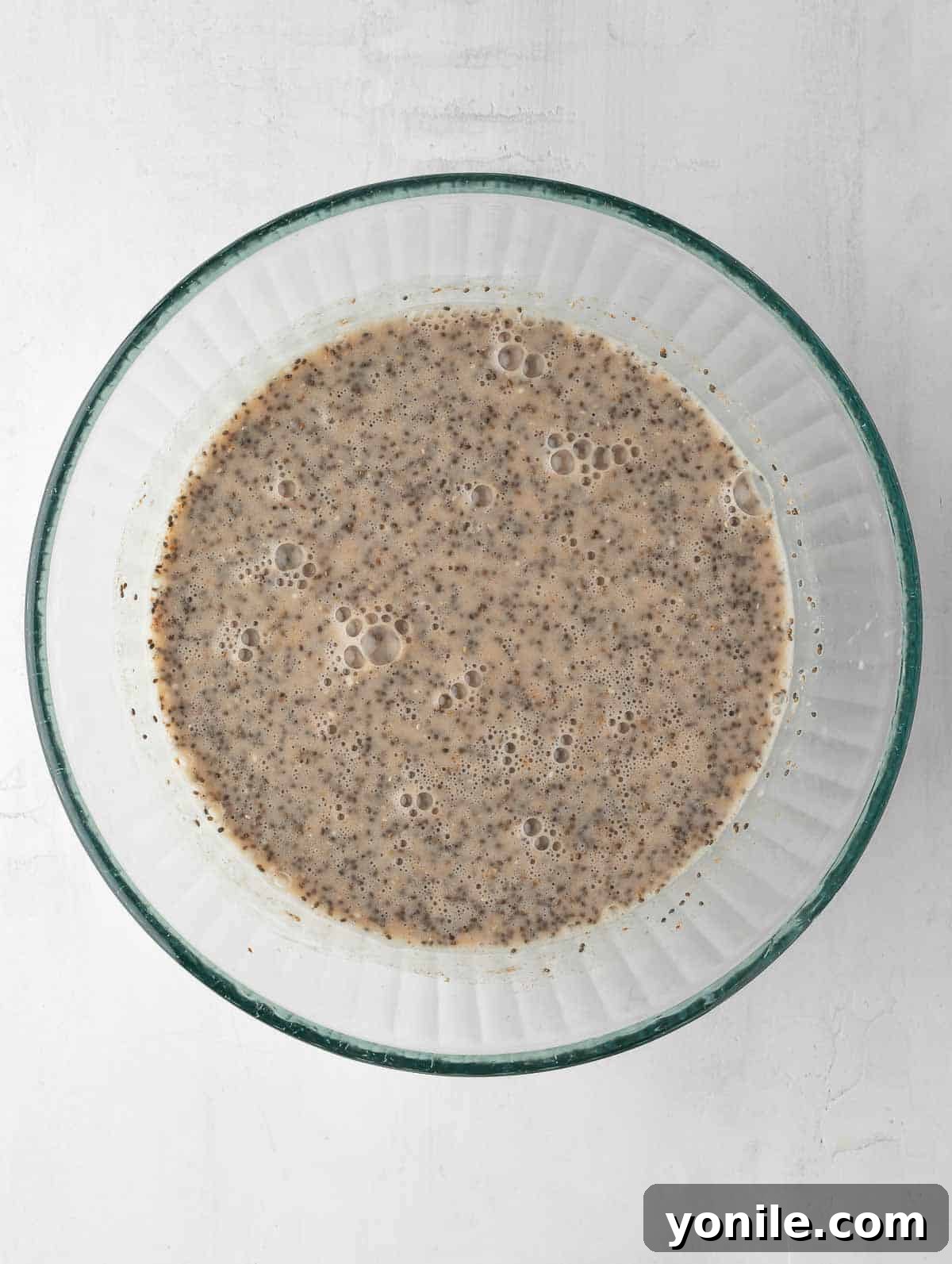 Smooth chia pudding base mixed with almond milk, before the addition of apples and further chilling.