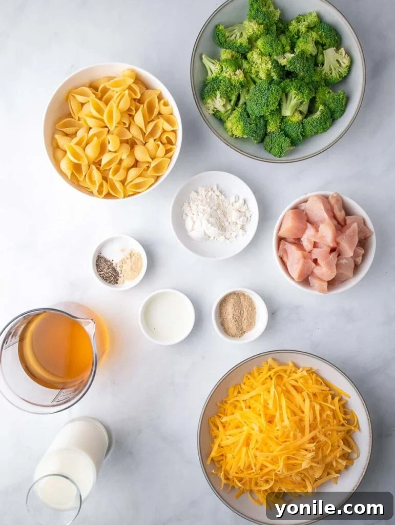 Ingredients for creamy broccoli mac and cheese laid out on a kitchen counter.