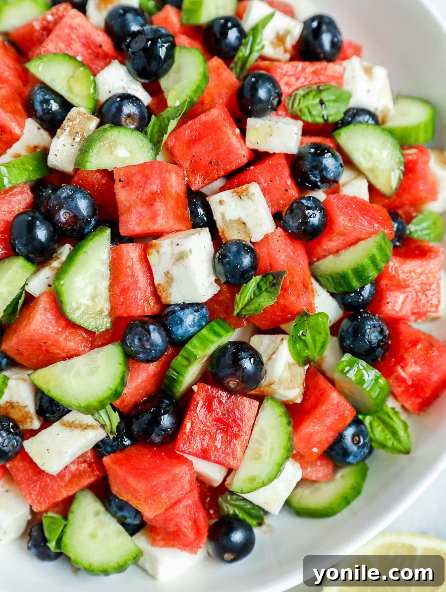 close up shot of the watermelon cucumber feta salad in a glass bowl