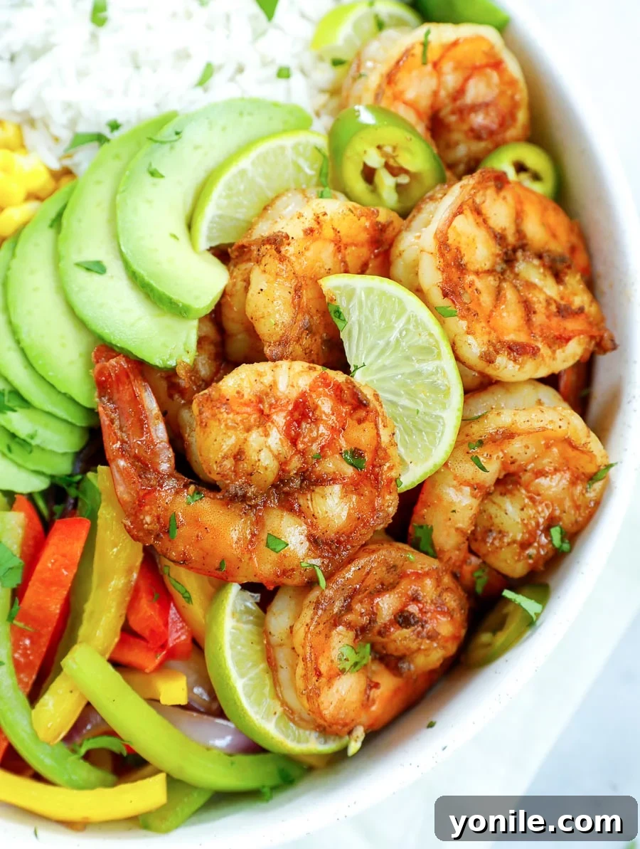 A beautifully assembled Healthy Chipotle Shrimp Bowl, ready to be eaten, showcasing all the colorful toppings.