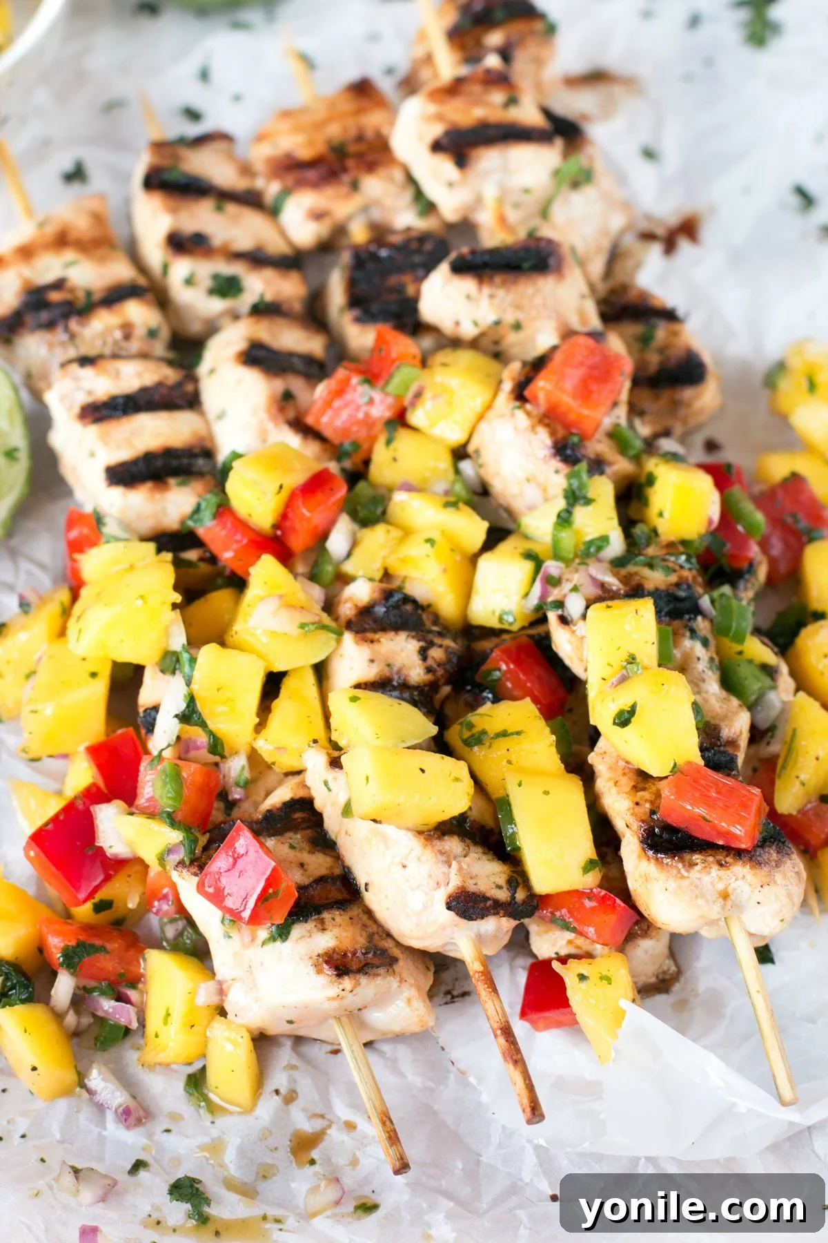Stacked mango chicken skewers with mango and bell pepper salsa
