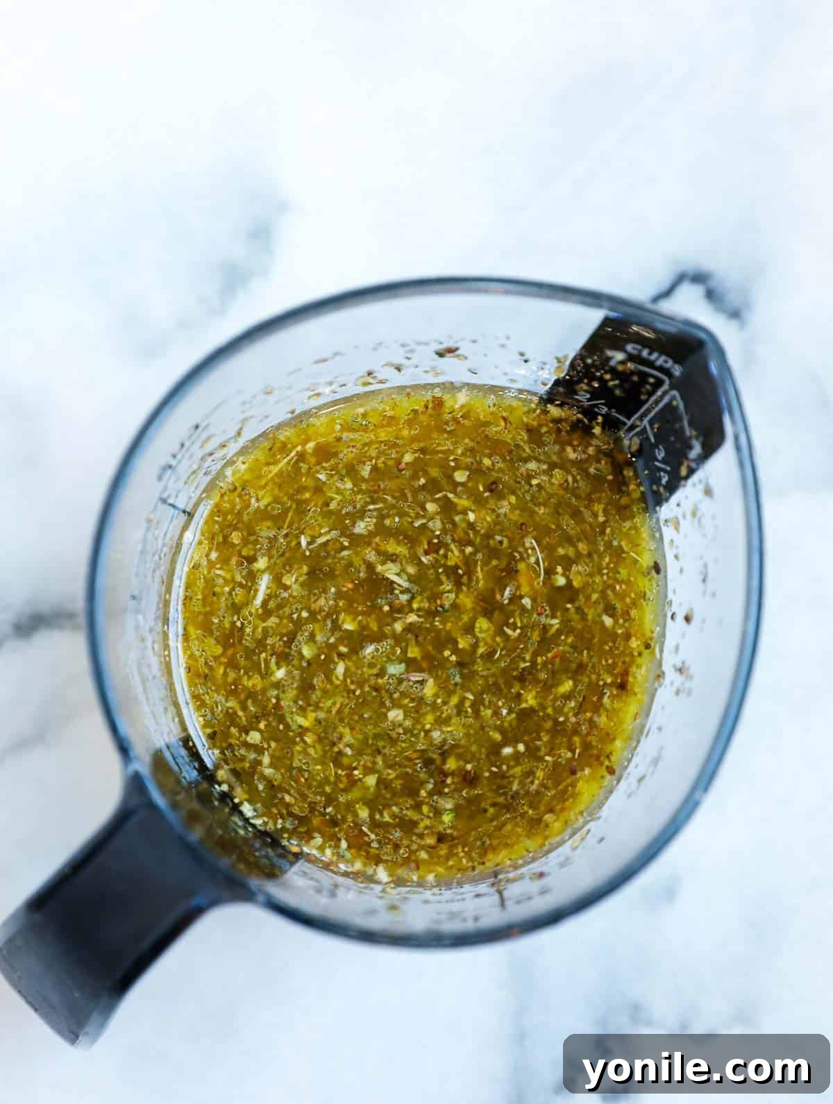 Zesty Mediterranean Pasta Salad 5 Salad dressing in a measuring cup.