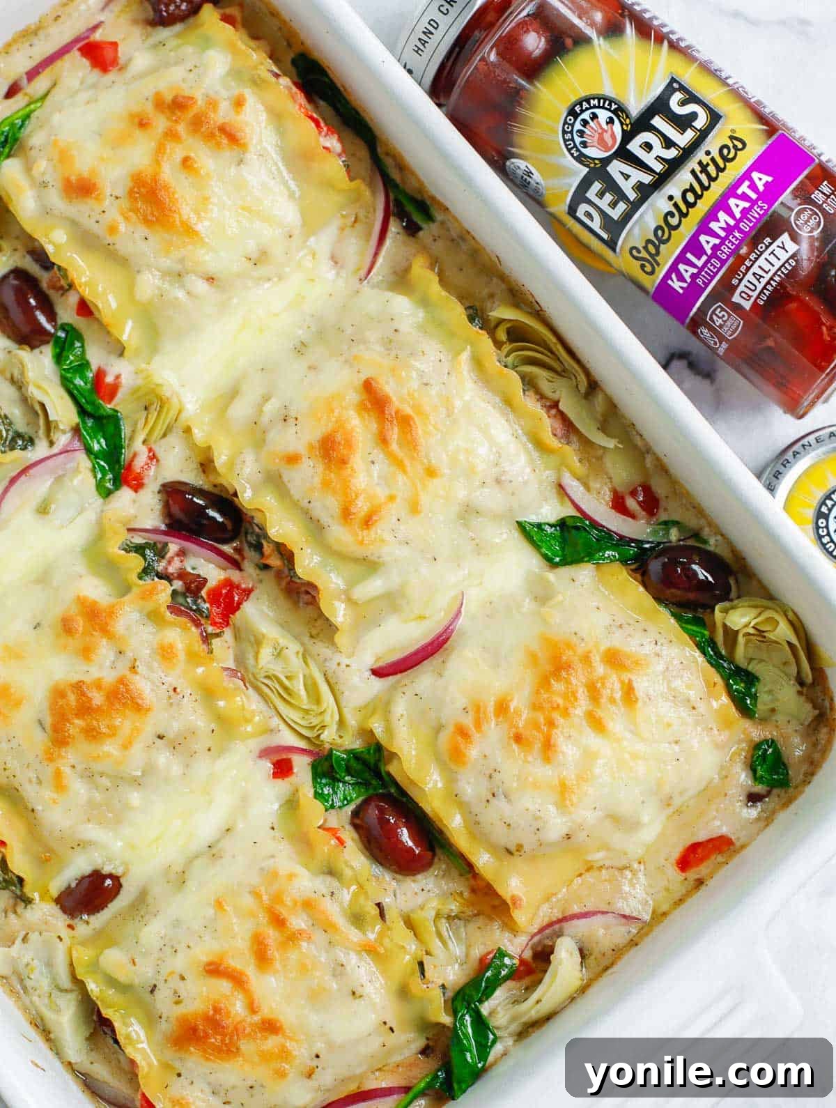 top down shot of the Greek White Alfredo Lasagna in a baking dish