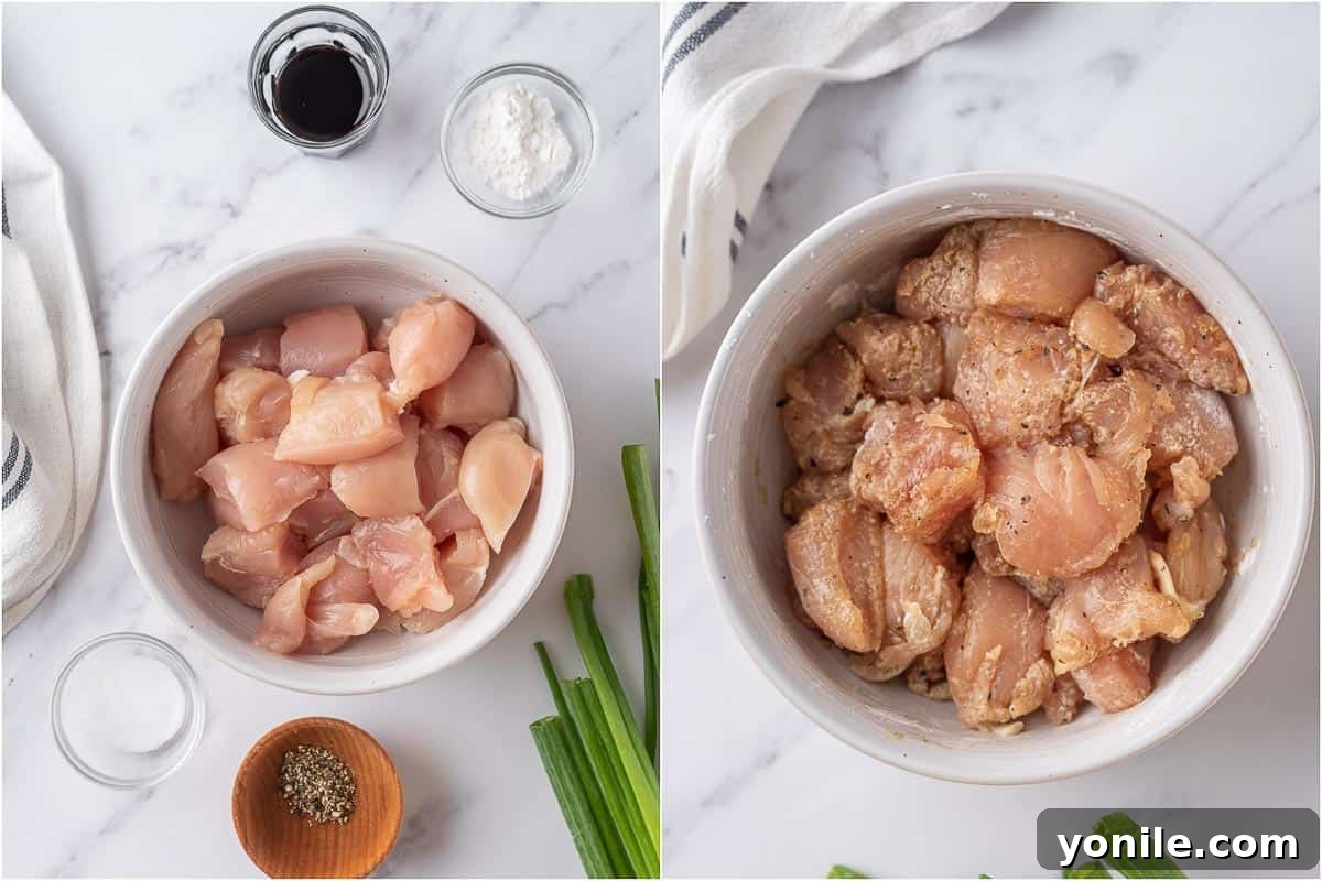Cubed chicken pieces marinating in a bowl, ready for the next step of the Crispy Honey Chicken recipe.
