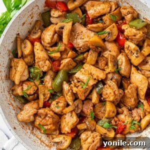 garlic butter chicken in a white skillet.