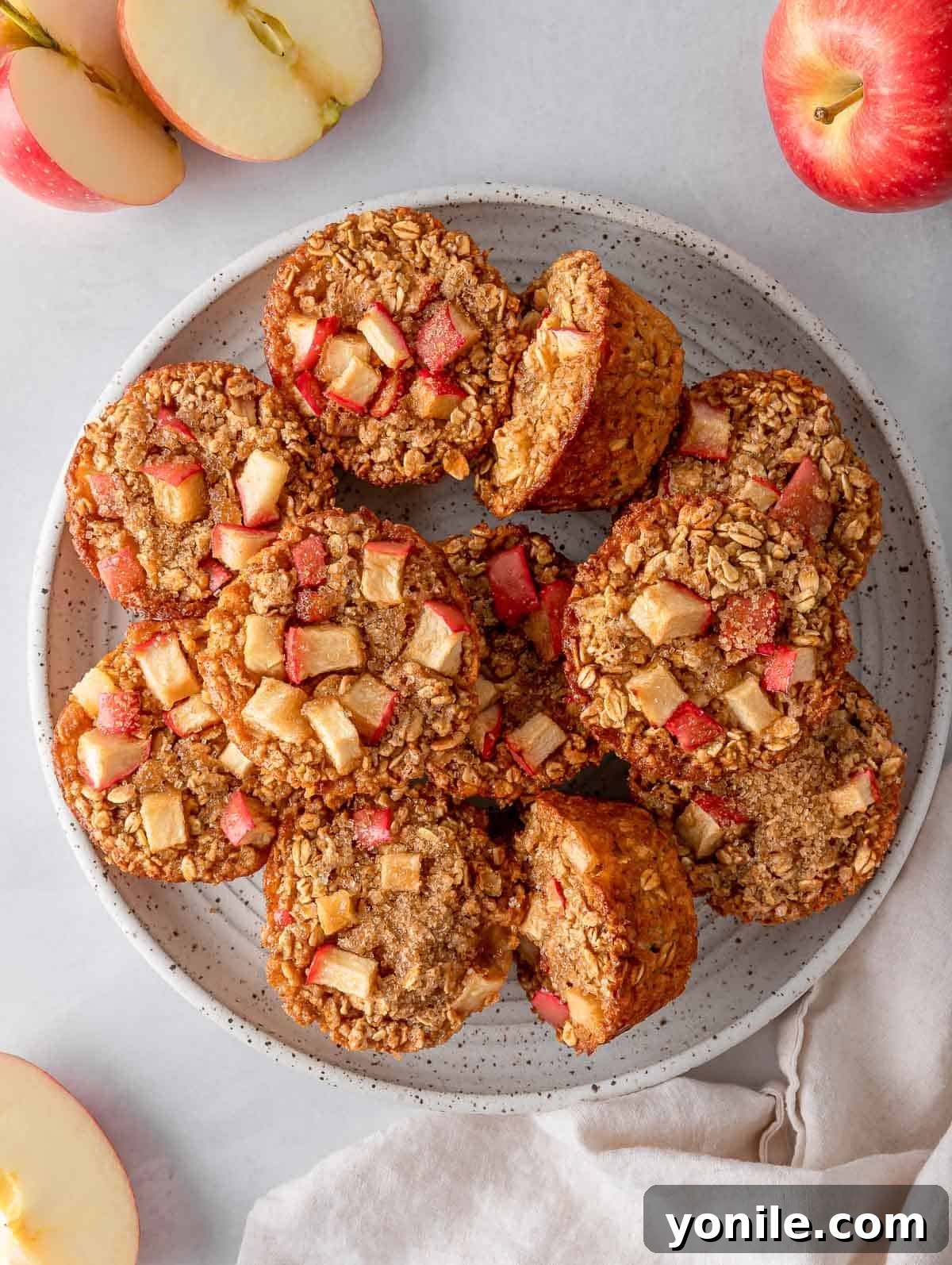 Overhead view of cinnamon baked apple oats cups on a plate, perfectly golden and ready to enjoy.