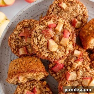 Overhead view of cinnamon baked apple oats cups on a plate.